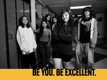 Students in hallway looking at camera